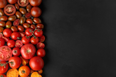 Photo of Flat lay composition with fresh ripe tomatoes on black background. Space for text