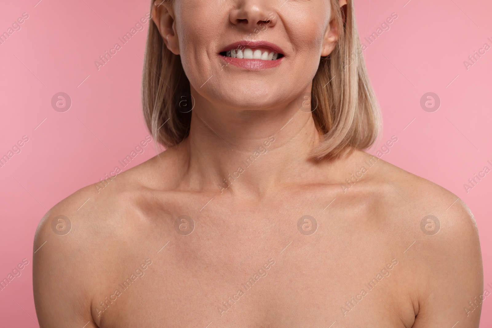 Photo of Woman with healthy skin on pink background, closeup