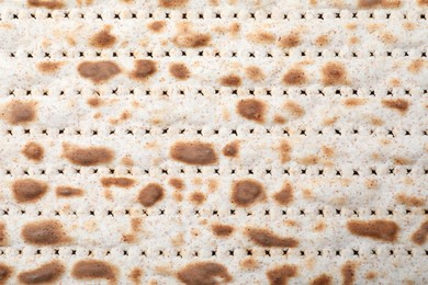 Photo of Traditional matzo as background, top view. Pesach celebration
