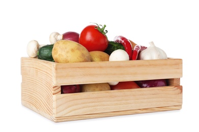 Wooden crate full of fresh vegetables on white background