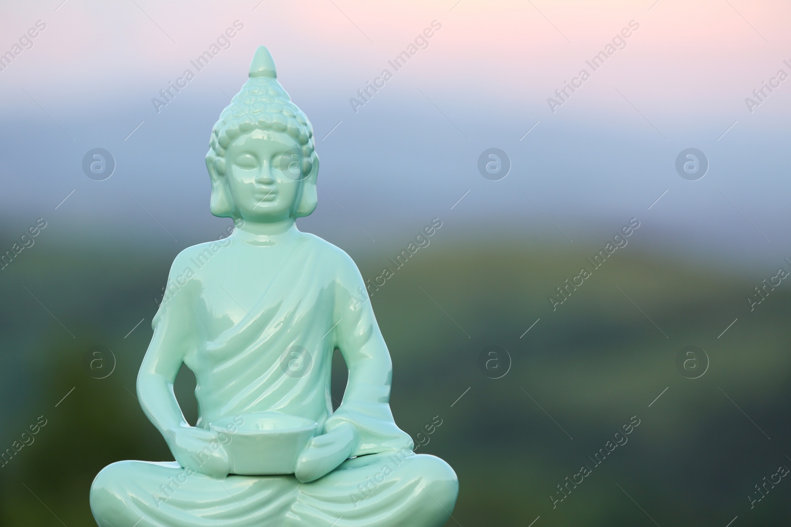 Photo of Decorative Buddha statue in mountains. Space for text