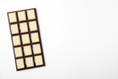 Photo of Tasty chocolate bar on white background, top view