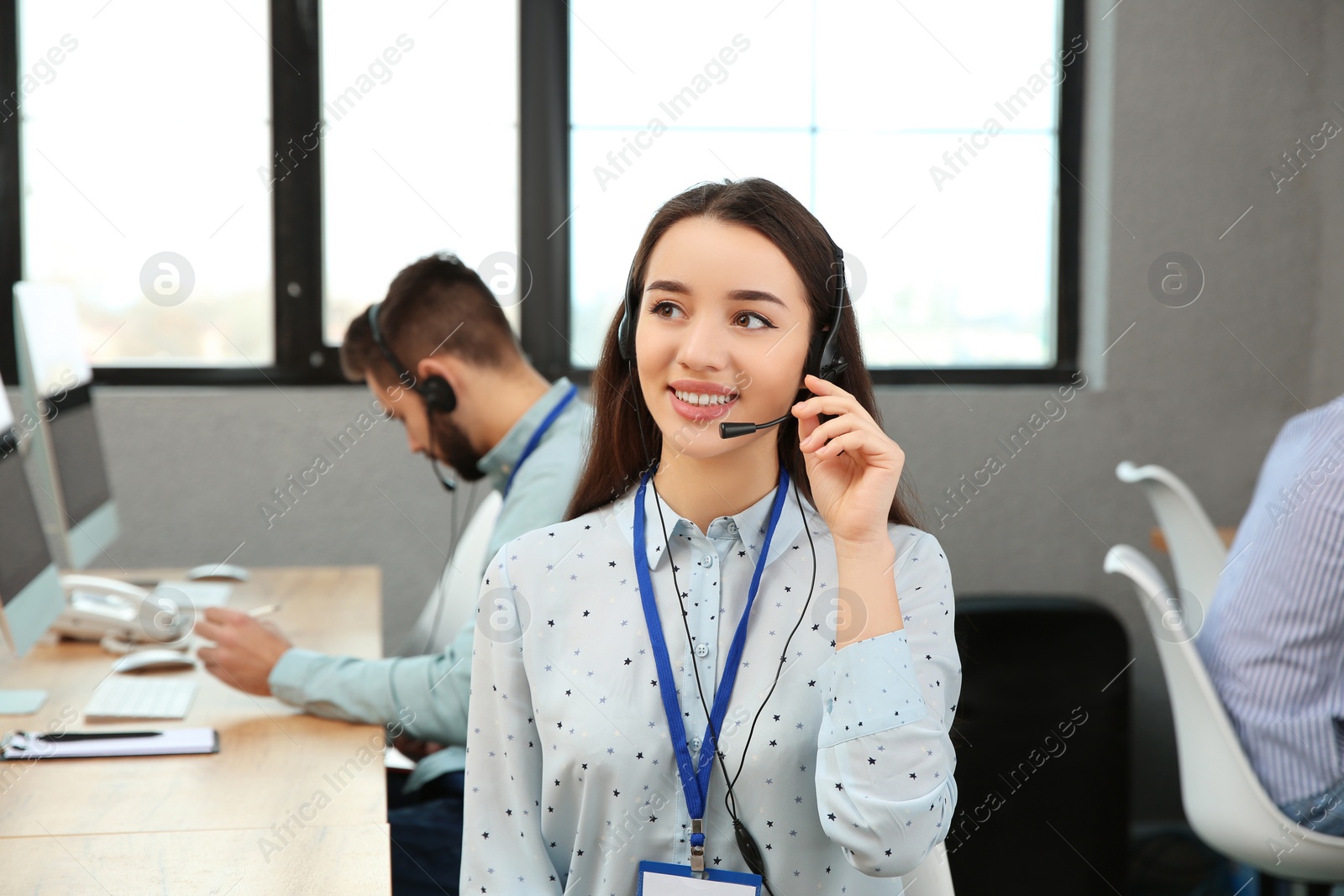 Photo of Technical support operator with colleagues in office