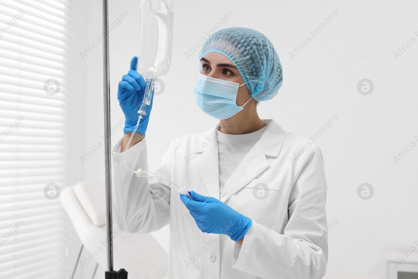 Photo of Nurse setting up IV drip in hospital