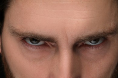 Evil eye. Man with scary eyes, closeup view