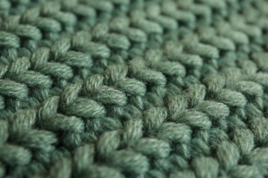 Photo of Beautiful pale green knitted fabric as background, closeup