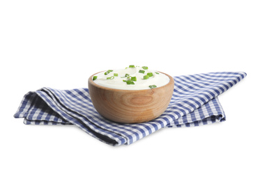 Fresh sour cream with onion and fabric on white background