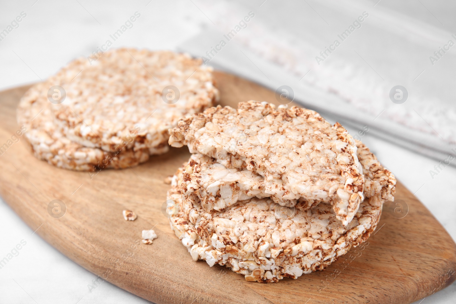 Photo of Crunchy buckwheat cakes on wooden board, closeup