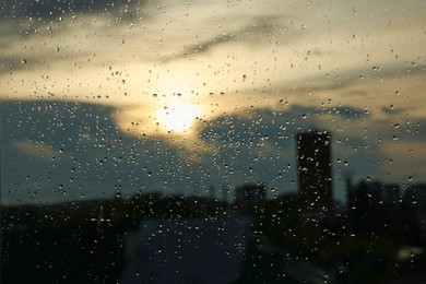 Photo of Window glass with droplets on rainy day, closeup