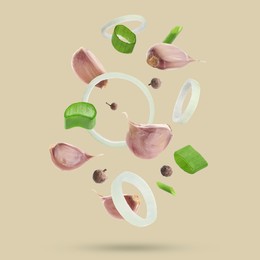 Image of Different spices falling on dark beige background