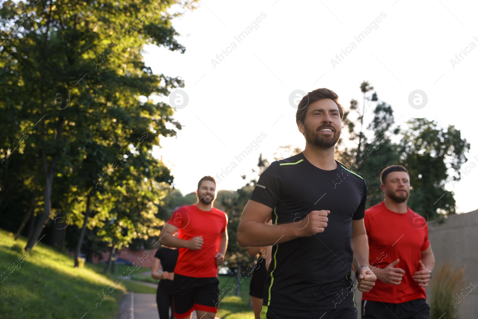 Photo of Group of people running outdoors, space for text. Active lifestyle