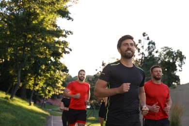 Photo of Group of people running outdoors, space for text. Active lifestyle