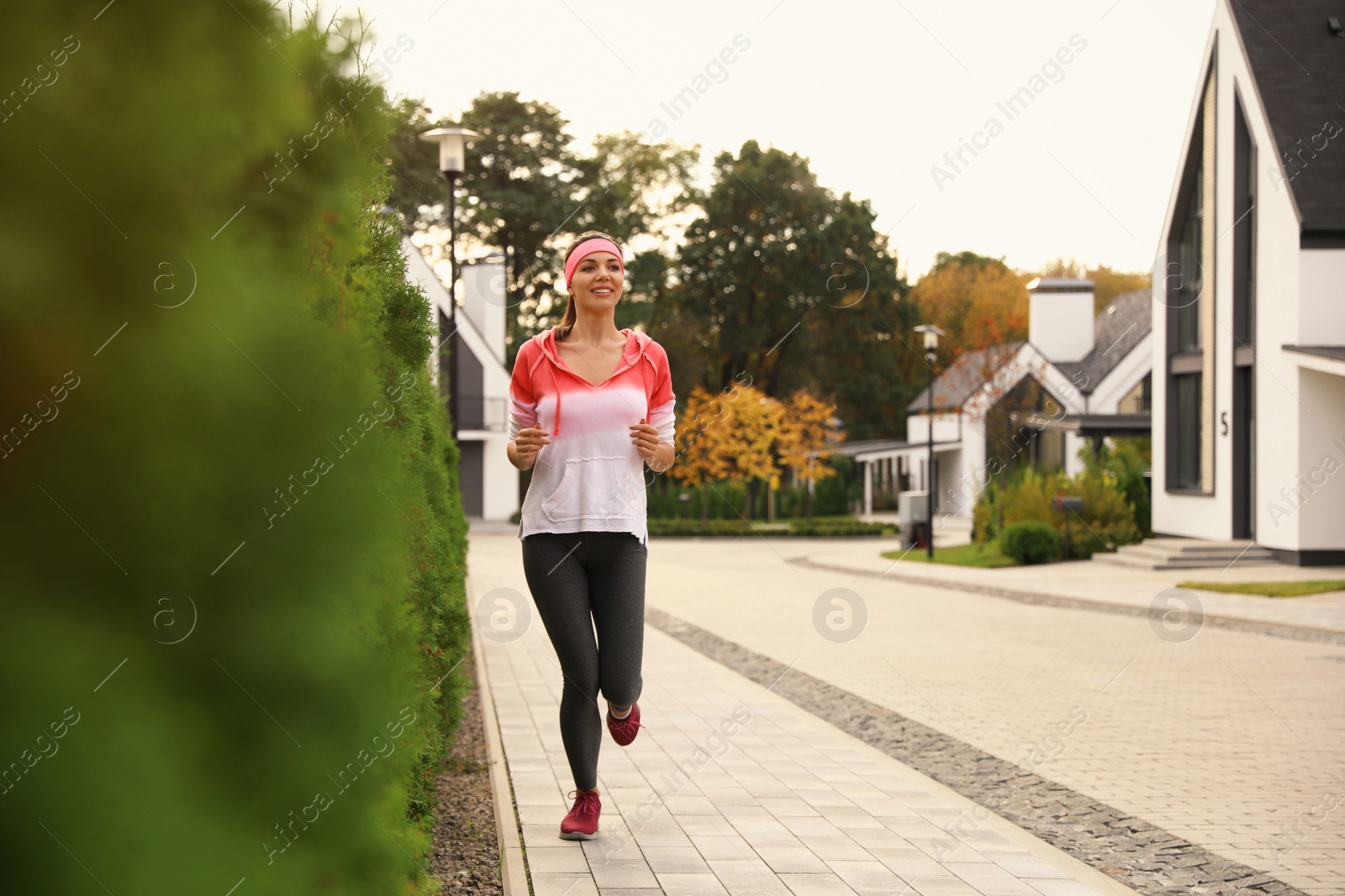 Photo of Beautiful sporty woman running on street. Healthy lifestyle