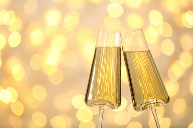 Photo of Glasses of champagne against blurred lights. Space for text