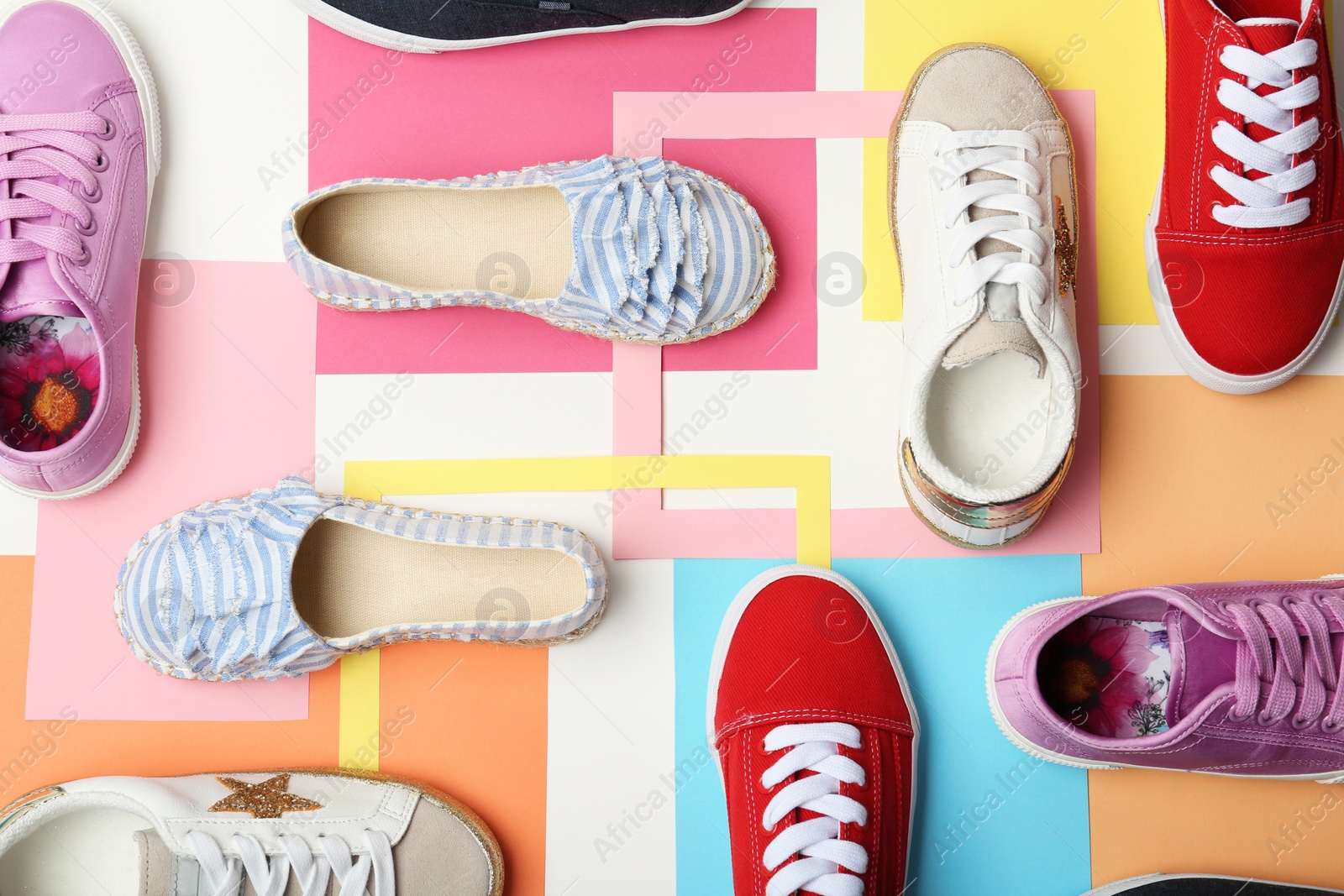 Photo of Flat lay composition with stylish new shoes on color background