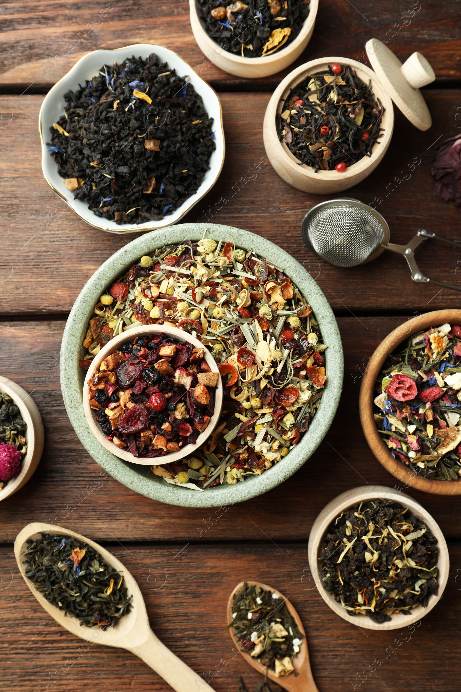 Photo of Many different herbal teas on wooden table, flat lay