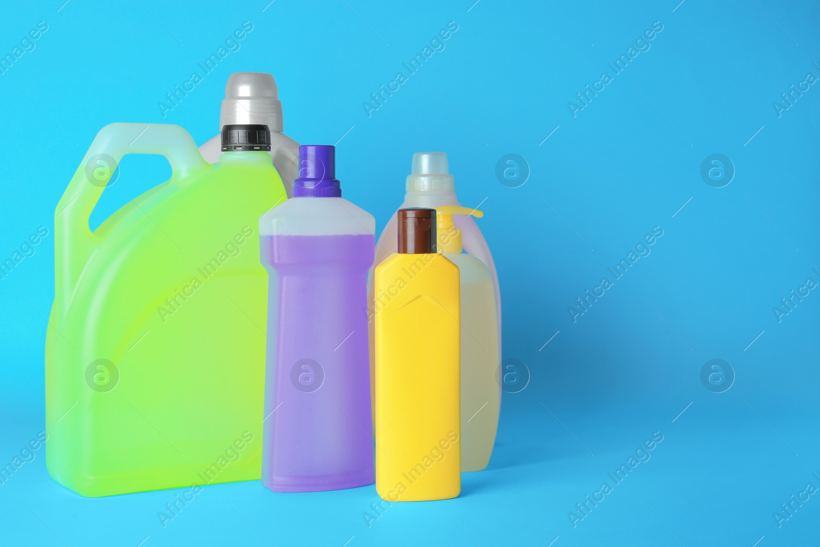 Photo of Many different cleaning supplies on light blue background, space for text