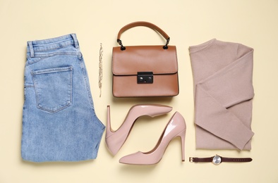 Photo of Flat lay composition with stylish clothes, shoes and accessories on beige background