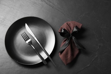 Photo of Stylish setting with elegant cutlery on grey textured table, flat lay