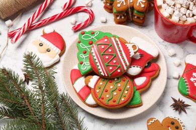 Photo of Flat lay composition with decorated Christmas cookies on white marble table