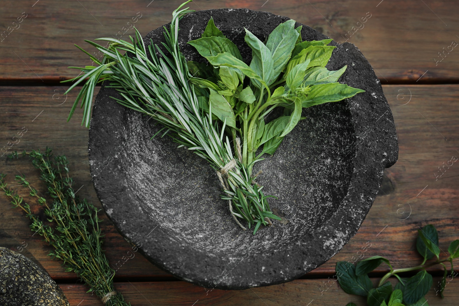 Photo of Thyme and rosemary on wooden table, flat lay. Aromatic herbs