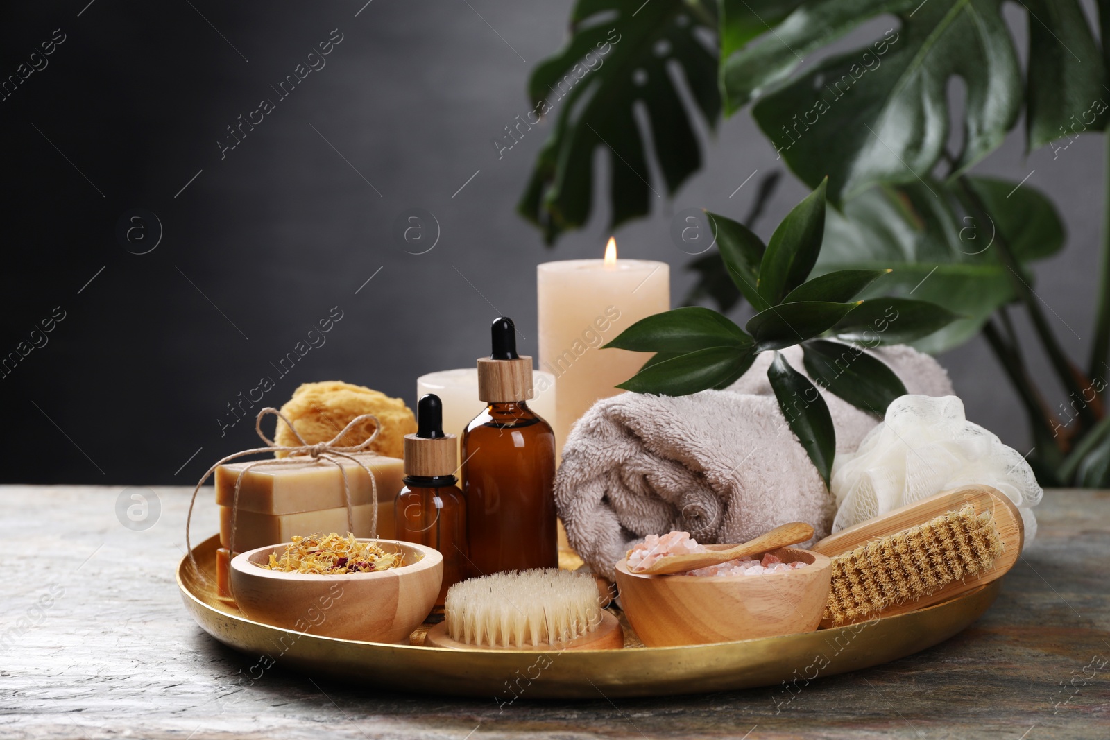 Photo of Spa composition. Brushes, bottles and sea salt on table