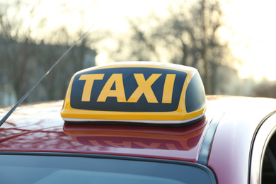 Photo of Roof light with word TAXI on car outdoors