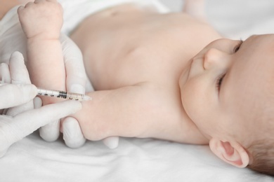 Doctor vaccinating baby in clinic