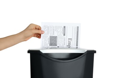 Woman destroying newspaper with paper shredder on white background, closeup