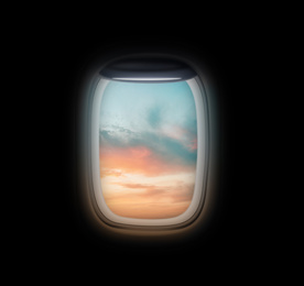 Image of View on beautiful sky through open airplane porthole at sunset