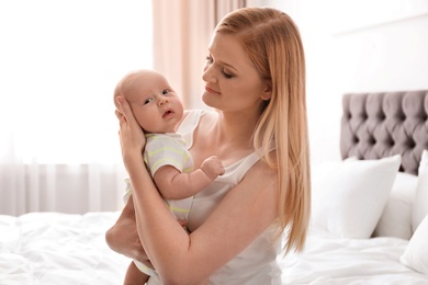 Mother with her little baby in bedroom