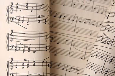 Photo of Sheets with music notes as background, top view