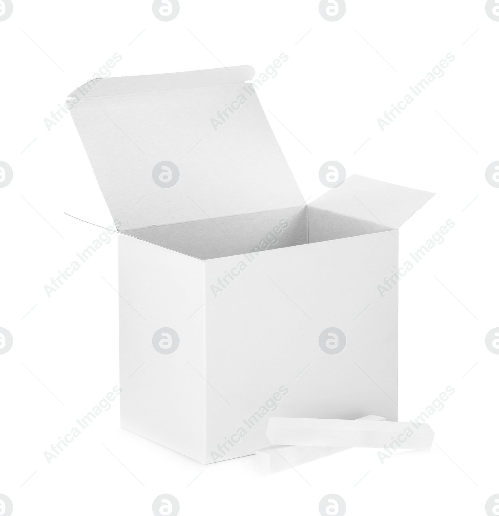 Photo of Open box and pieces of chalk on white background