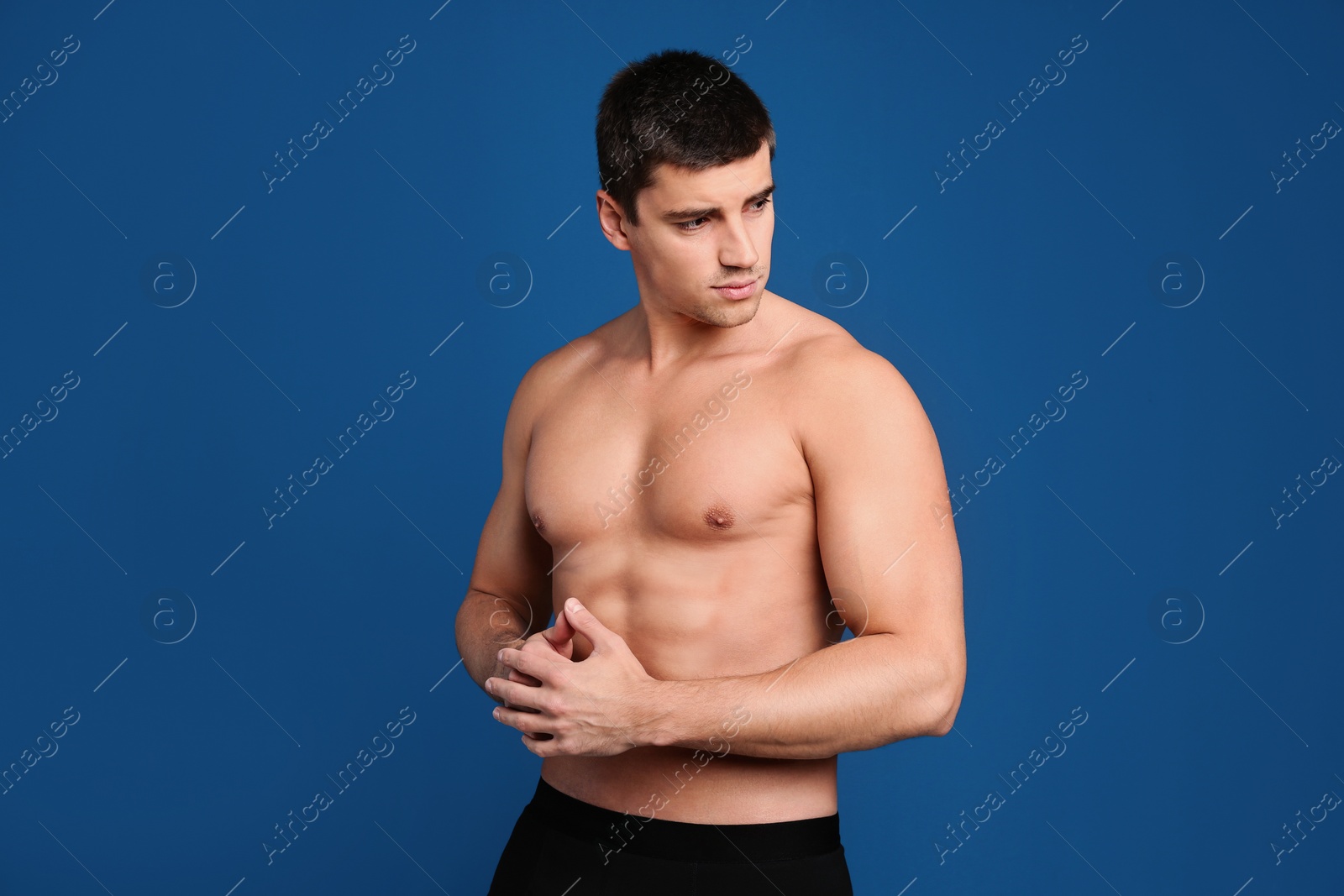 Photo of Man with sexy body on blue background