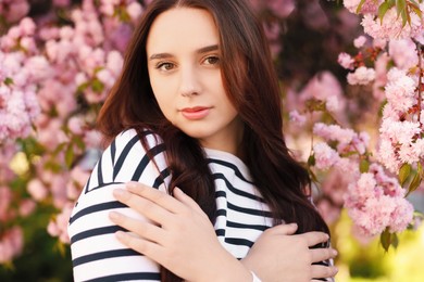 Photo of Beautiful woman near blossoming tree on spring day