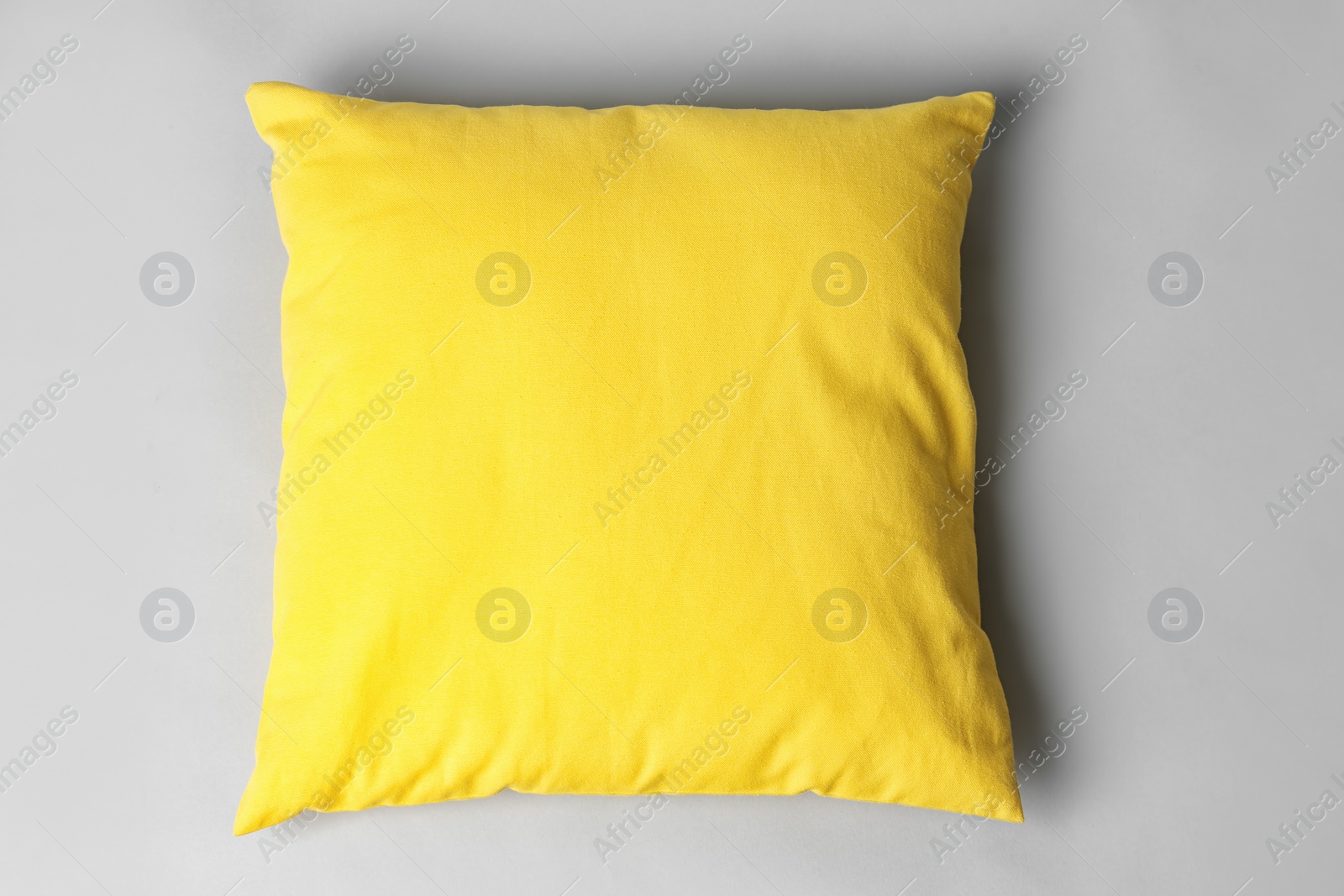 Photo of Soft decorative pillow on light background