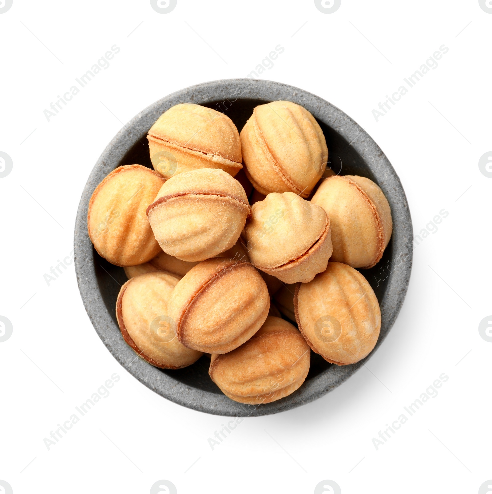 Photo of Bowl of delicious nut shaped cookies with condensed milk on white background, top view