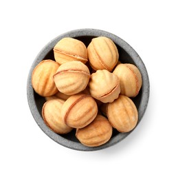 Photo of Bowl of delicious nut shaped cookies with condensed milk on white background, top view