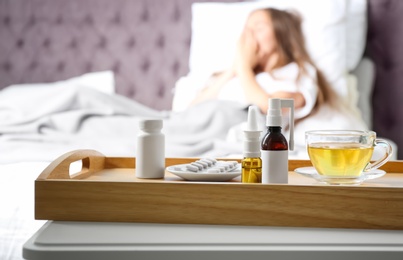 Photo of Different cold remedies and sick woman on background