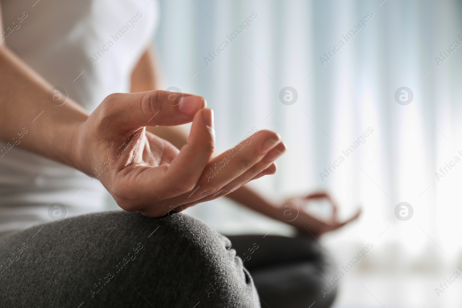 Photo of Woman practicing yoga indoors, closeup. Space for text