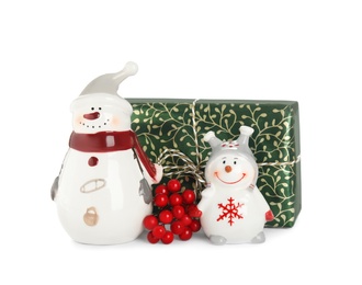 Christmas composition with decorative snowmen and gift box on white background