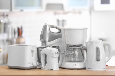 Photo of Different modern kitchen appliances on table indoors. Interior element