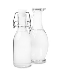 Vinegar in glass bottle and jug isolated on white