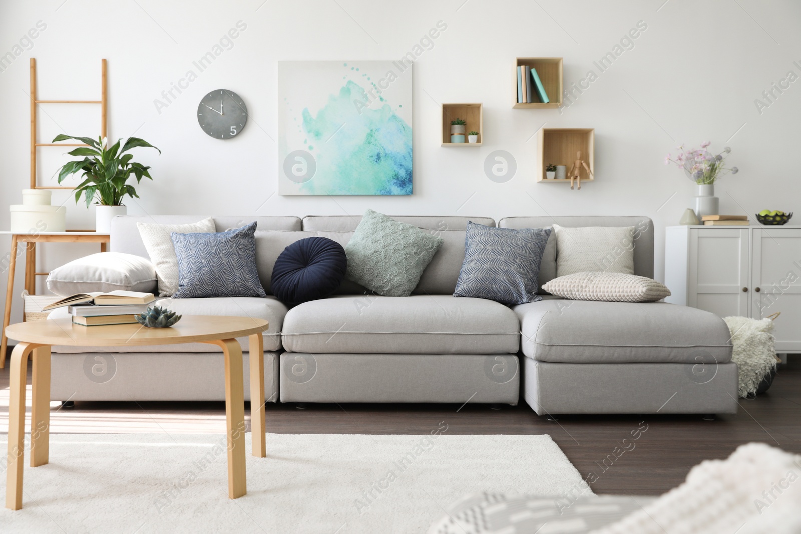 Photo of Elegant living room with comfortable sofa and wooden table. Interior design