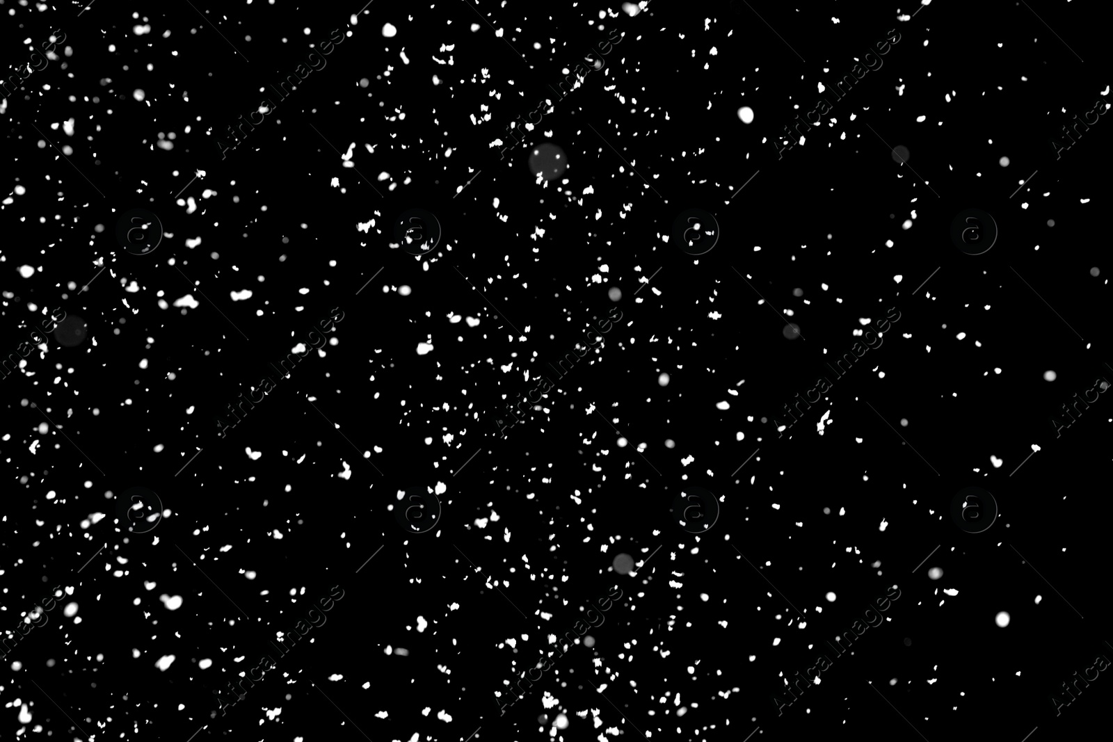 Photo of White snow falling down on black background