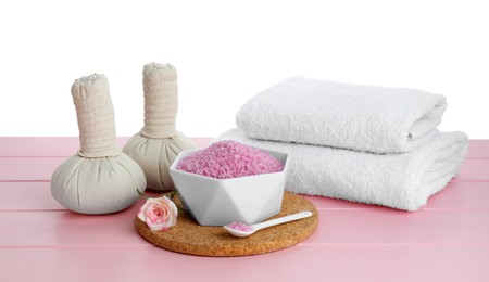 Photo of Composition with sea salt and herbal bags on pink wooden table against white background