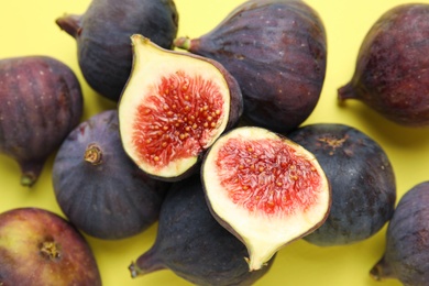 Delicious ripe figs on yellow background, closeup