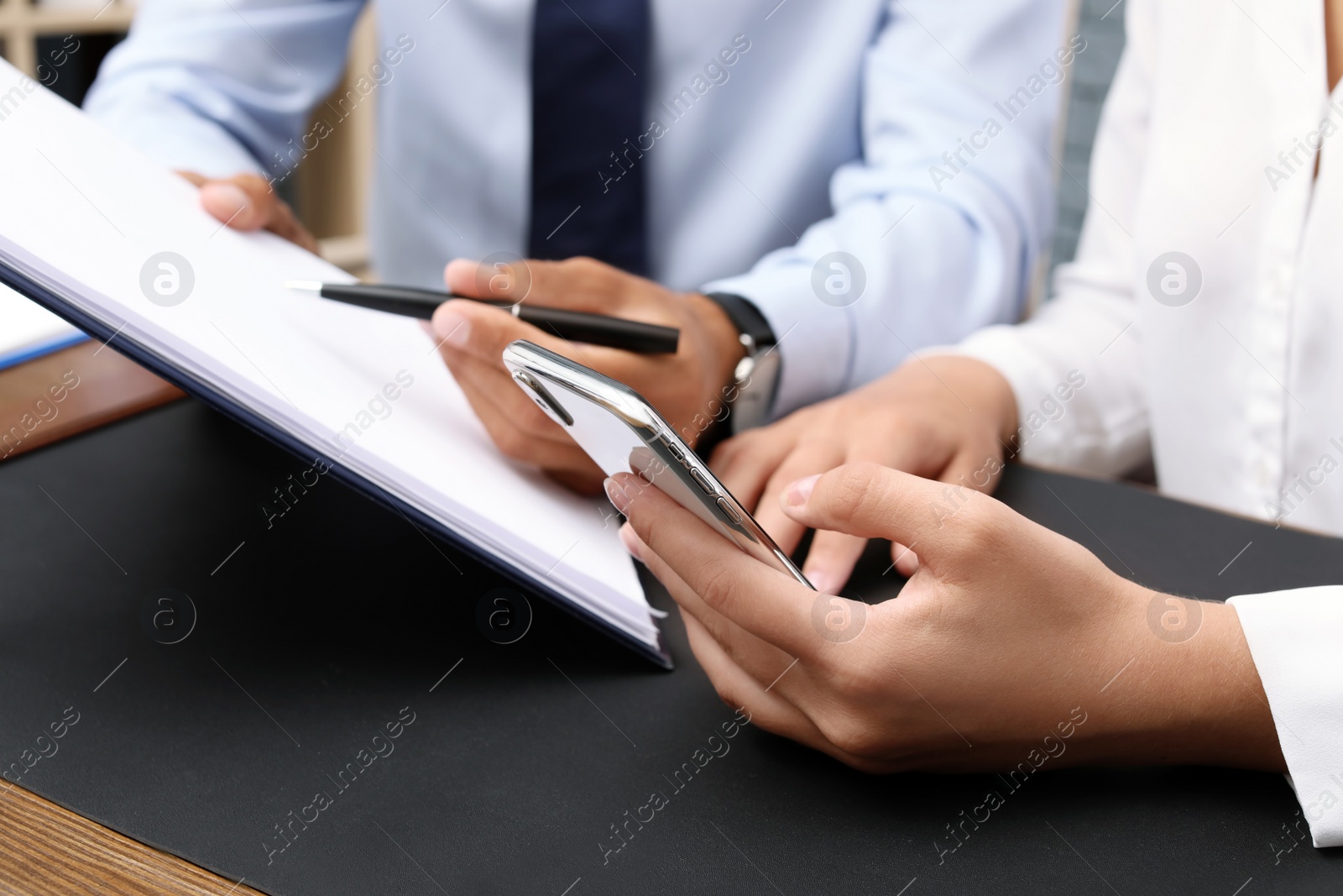 Photo of Lawyer working with client at table, closeup. Notary services