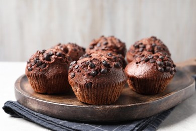 Photo of Tasty chocolate muffins on grey table, closeup