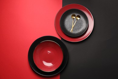 Photo of Stylish table setting with plates and spoons on color background, top view